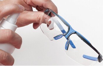 Spray small amount of cleaning fluid onto both sides of the lens Spray small amount of cleaning fluid onto both sides of the lens