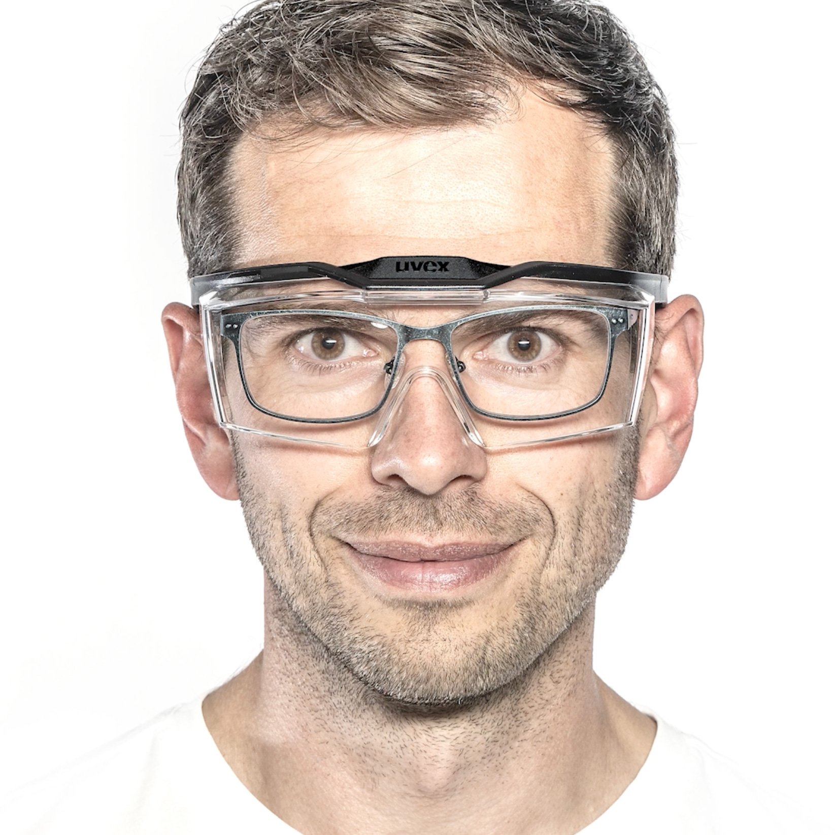Man with rectangular prescription spectacles and uvex OTG plus overspecs