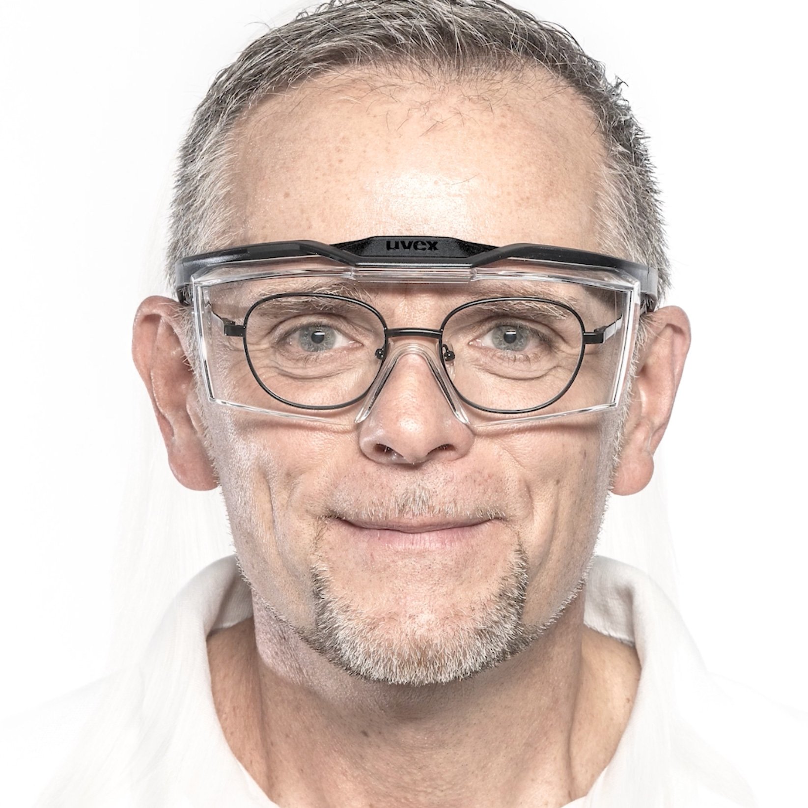 Man with oval prescription spectacles and uvex OTG plus overspecs