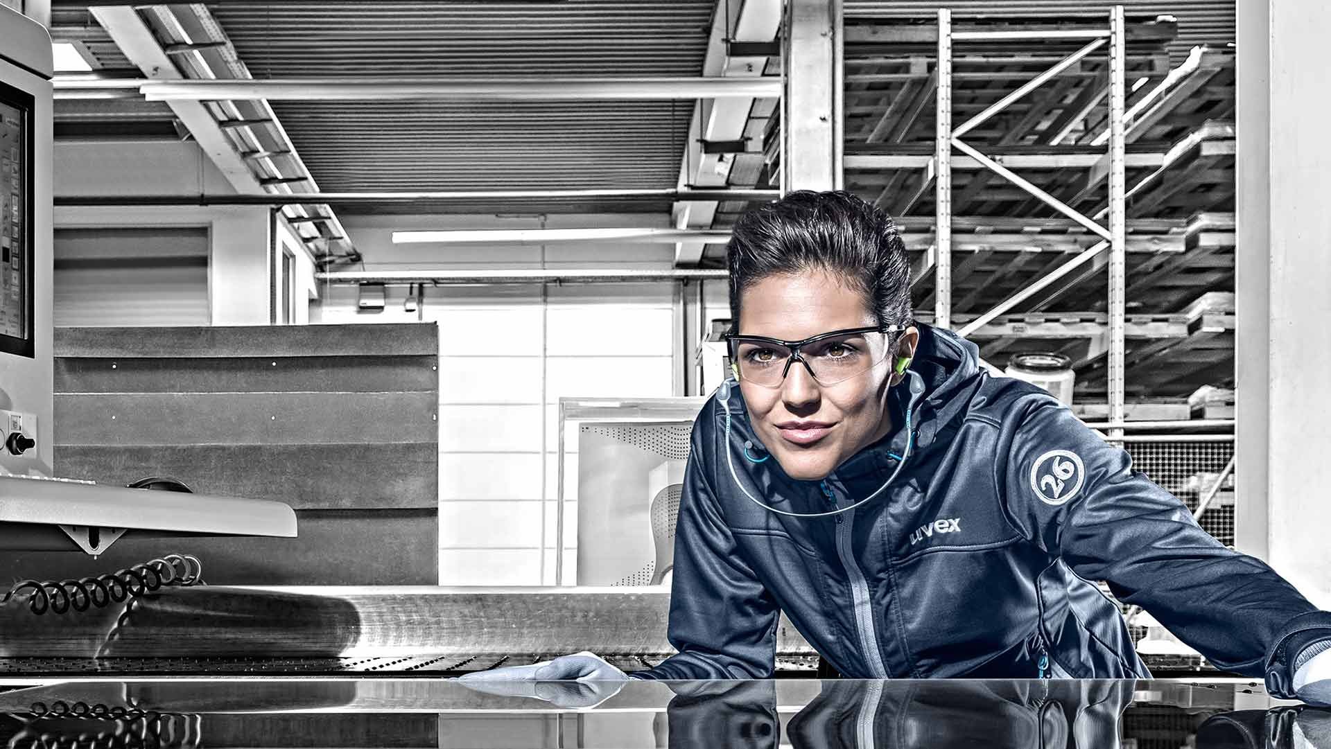 Female employee wearing uvex safety eyewear and hearing protection