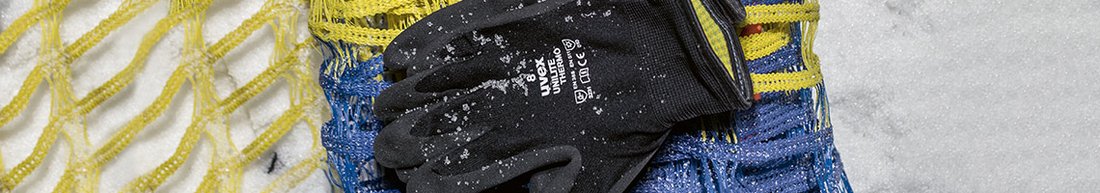 uvex unilite thermo safety glove laying on snow